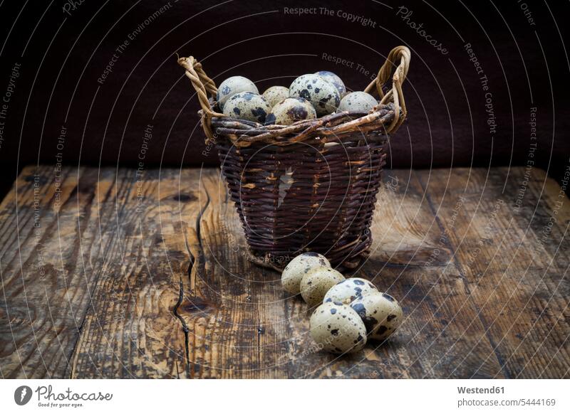 Wickerbasket of quail eggs on dark wood still life still-lifes still lifes brown rustic dotted flecked mottled speckled spotted Brown Background