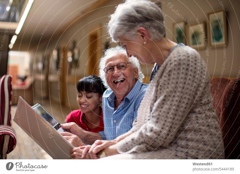 Nurse teaching seniors in retirement home, how to use laptop sharing share nursing home geriatric nurse senior women elder women elder woman old senior woman