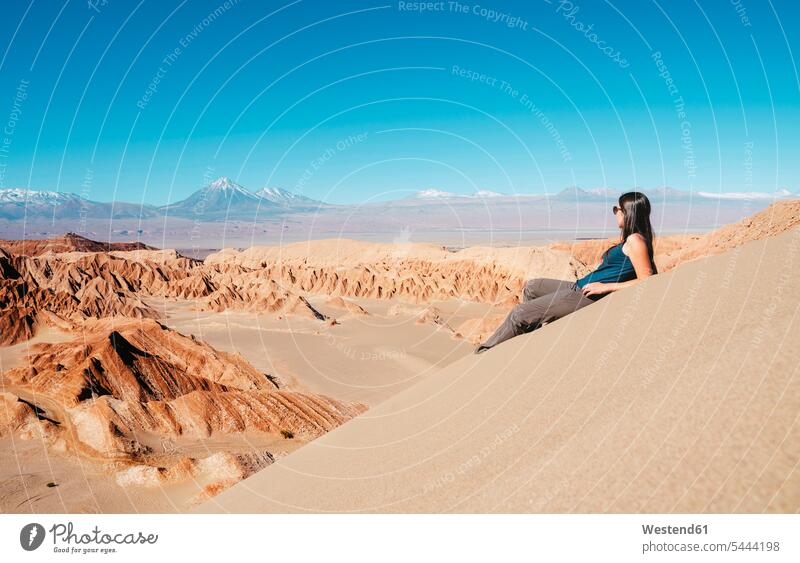 Chile, Atacama Desert, woman sitting on dune looking at view females women sand dune sand dunes Adults grown-ups grownups adult people persons human being