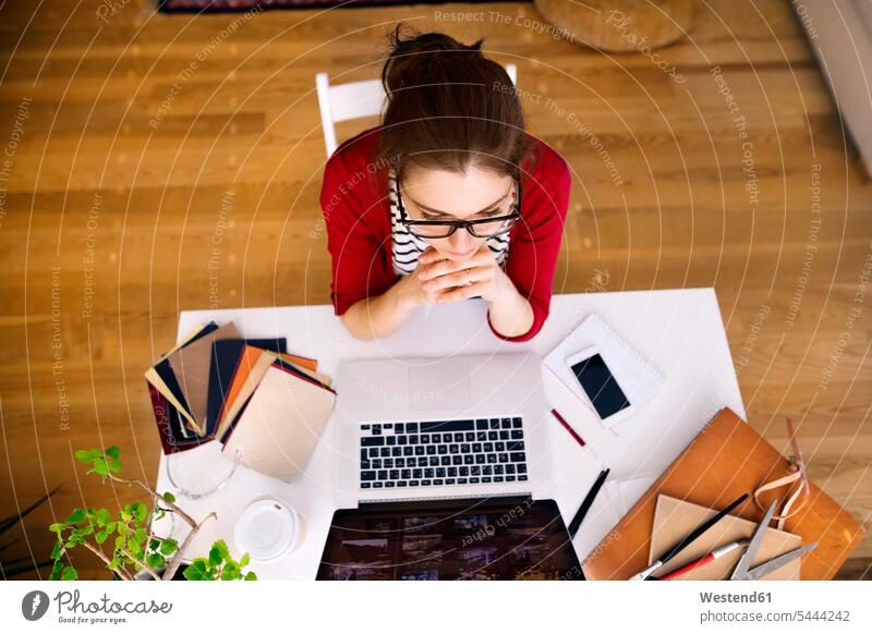 Woman working at desk at home woman females women laptop Laptop Computers laptops notebook home office working from home home business Adults grown-ups grownups