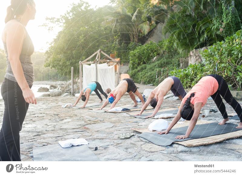 Mexico, Mismaloya, instructor with yoga class at ocean front sea coast coastline coast area Seacoast seaside Yoga coach coaches trainer instructors water waters