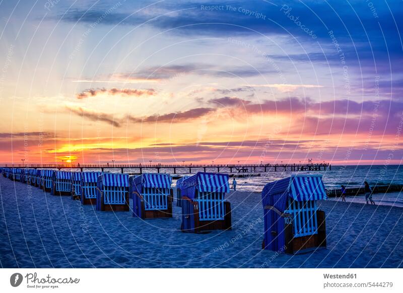Germany, Kuehlungsborn, sea bridge and beach chairs at sunrise hooded beach chair roofed wicker beach chair Hooded Beach Chairs aurora red sky relaxation