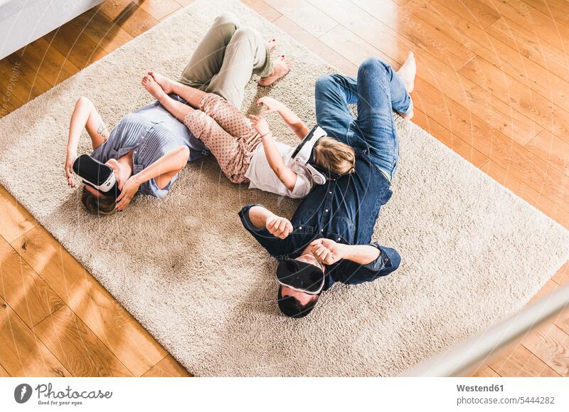 Family using VR goggles at home carpet carpets rug rugs interactive interactivity wearable wearable computers wearables Virtual Reality Glasses VR glasses