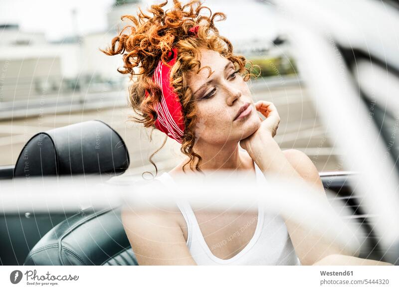 Portrait of redheaded woman in sports car females women portrait portraits automobile Auto cars motorcars Automobiles Adults grown-ups grownups adult people