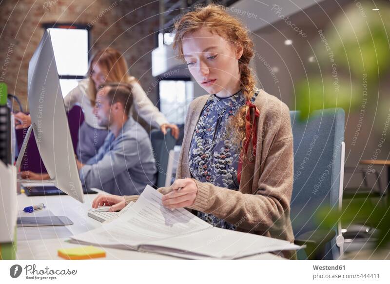 Young woman working in modern creative office, usine laptop reading At Work offices office room office rooms creative professional Creative People creatives