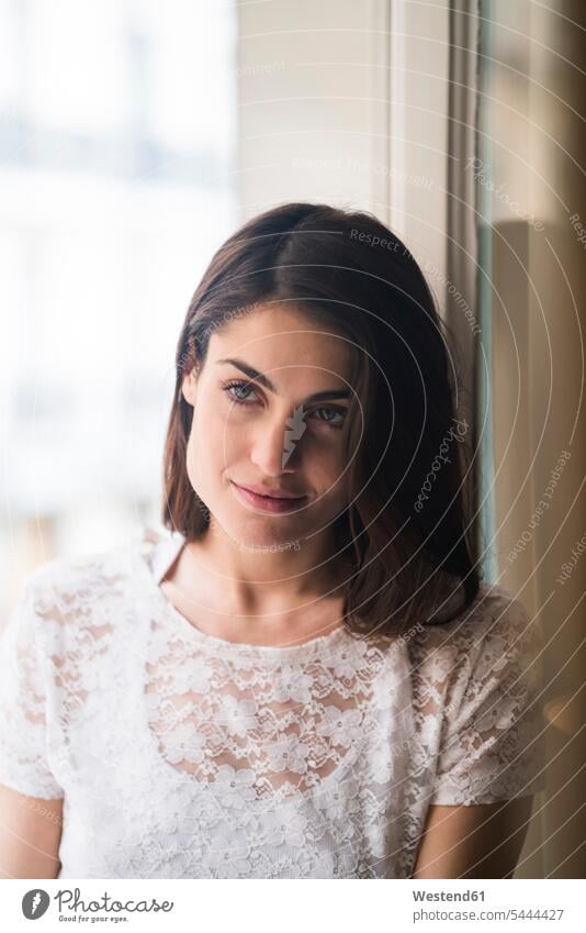 Portrait of content woman in front of window portrait portraits females women Adults grown-ups grownups adult people persons human being humans human beings