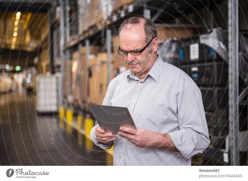 Man using tablet in factory warehouse factories digitizer Tablet Computer Tablet PC Tablet Computers iPad Digital Tablet digital tablets man men males computer