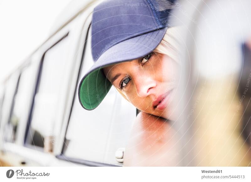 Young woman looking out of window of a van portrait portraits smiling smile females women Adults grown-ups grownups adult people persons human being humans
