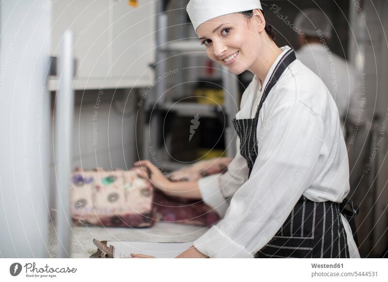 Portrait of smiling woman in a butchery meat charcuterie working At Work smile portrait portraits Food foods food and drink Nutrition Alimentation