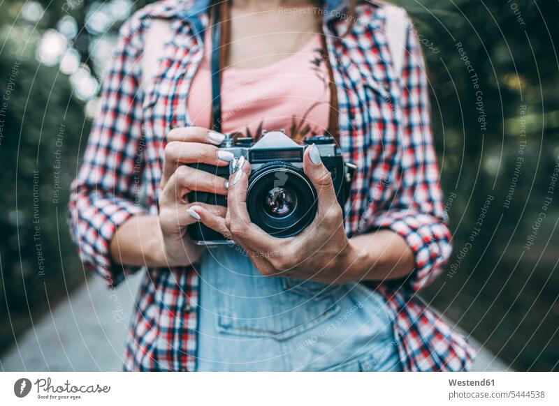 Close-up of woman with a camera cameras female photographer females women photographers Adults grown-ups grownups adult people persons human being humans