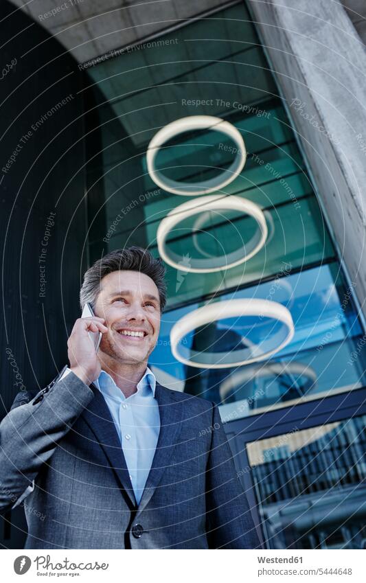 Portrait of smiling businessman on the phone Businessman Business man Businessmen Business men portrait portraits call telephoning On The Telephone calling