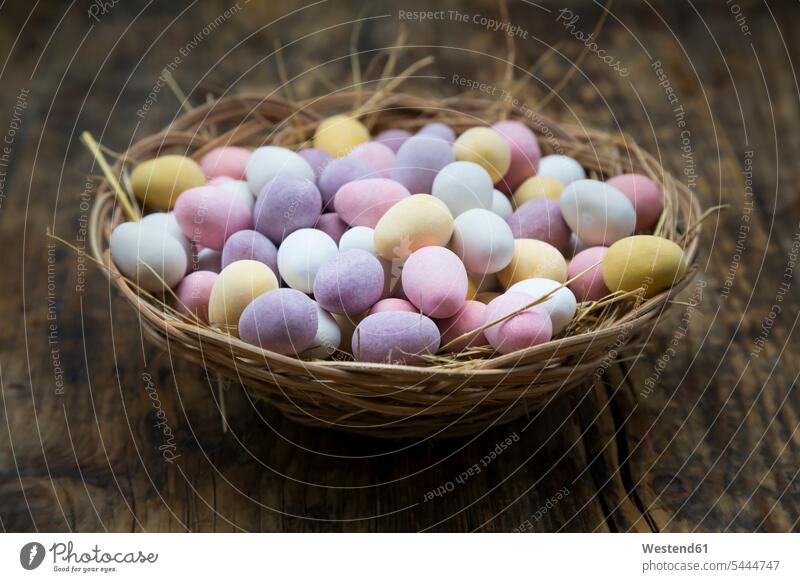 Easter nest of Chocolate Easter eggs focus on foreground Focus In The Foreground focus on the foreground Chocolates wooden large group of objects many objects