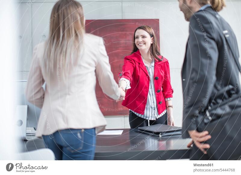 Business people shaking hands in office business people businesspeople Handclasp Handclap businesswoman businesswomen business woman business women offices