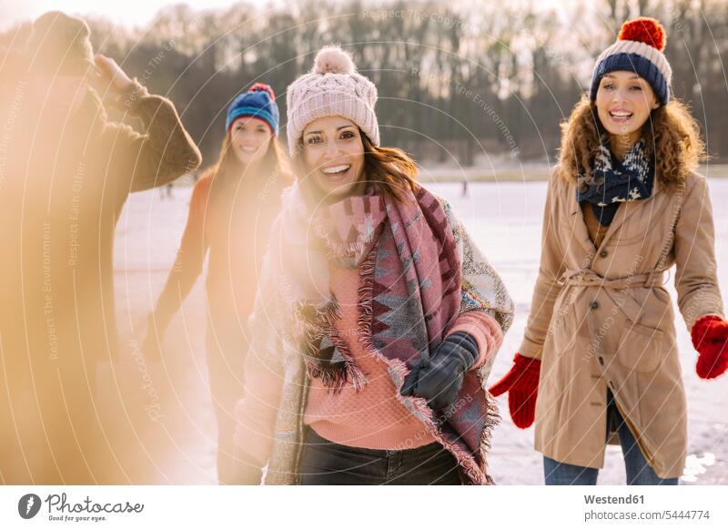 Portrait of happy friends outdoors in winter laughing Laughter happiness positive Emotion Feeling Feelings Sentiments Emotions emotional friendship portrait