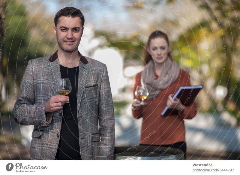 Man and woman with glasses of wine outdoors Wine Tasting wine-tasting winetasting marketing Wine Glass Wine Glasses Wineglass Wineglasses salesperson