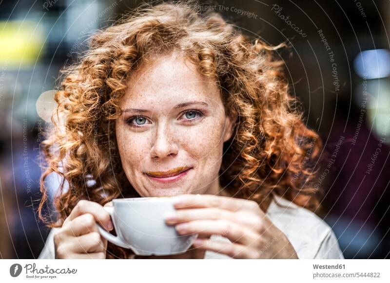Portrait of smiling young woman with coffee cup Coffee females women portrait portraits Drink beverages Drinks Beverage food and drink Nutrition Alimentation