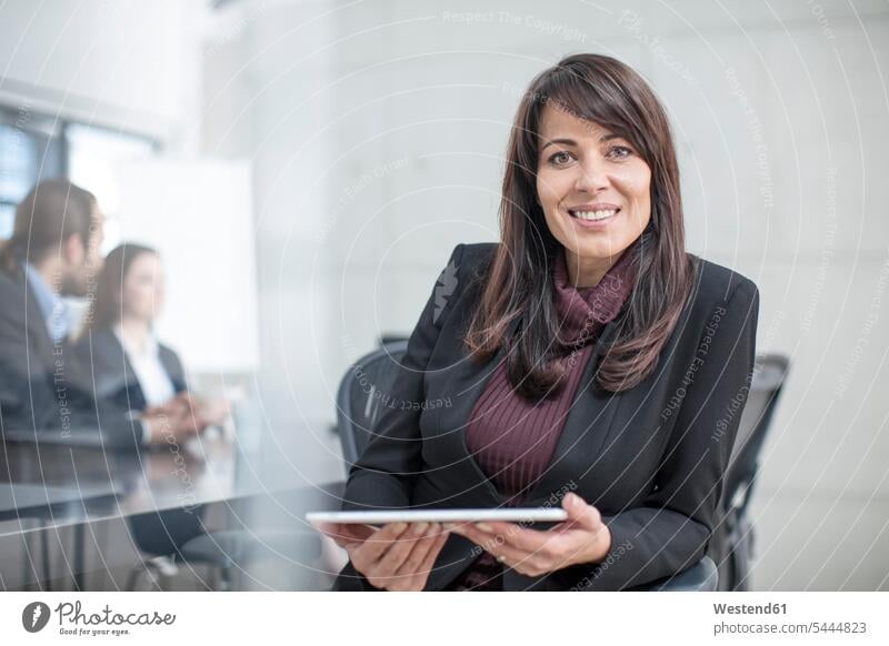 Portrait of smiling businesswoman with tablet on a meeting in conference room digitizer Tablet Computer Tablet PC Tablet Computers iPad Digital Tablet