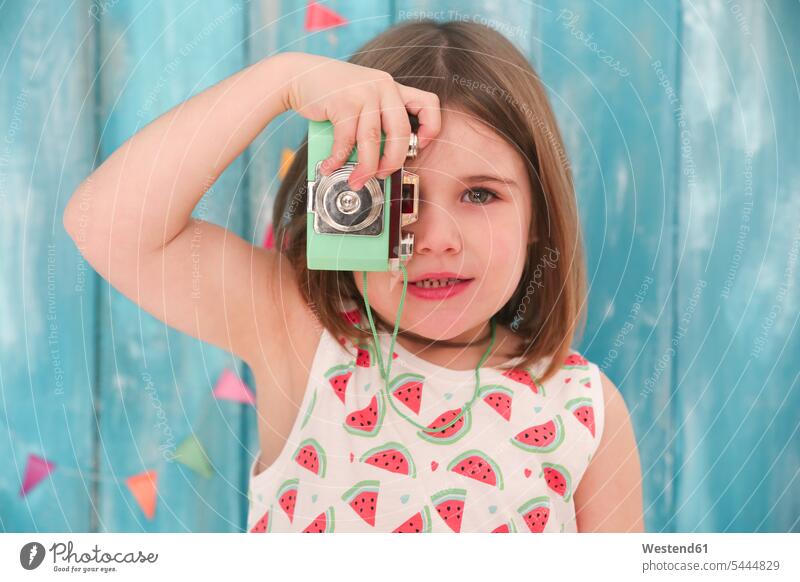 Portrait of little girl playing with vintage toy camera cameras toys females girls child children kid kids people persons human being humans human beings