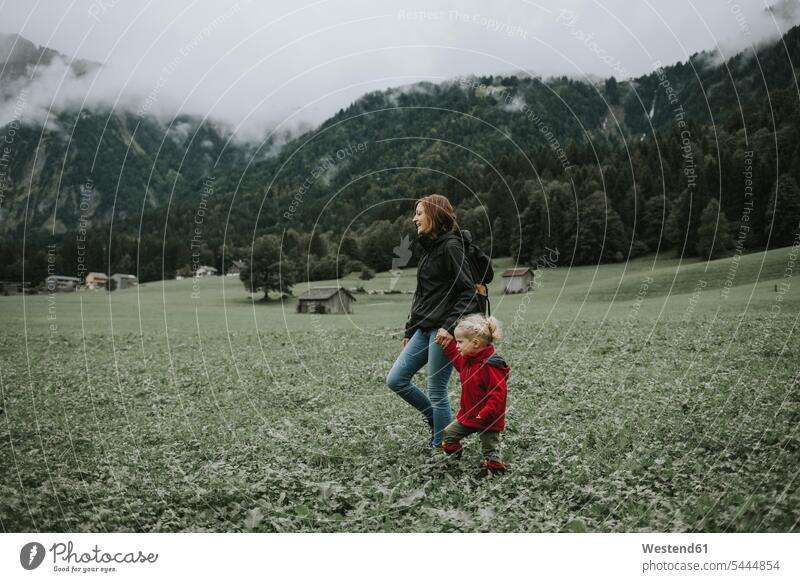 Austria, Vorarlberg, Mellau, mother and toddler on a trip in the mountains walking going daughter daughters forest woods forests mommy mothers ma mummy mama