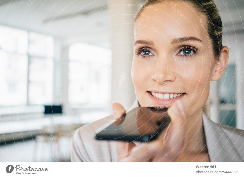 Portrait of smiling businesswoman using cell phone businesswomen business woman business women on the phone call telephoning On The Telephone calling Smartphone