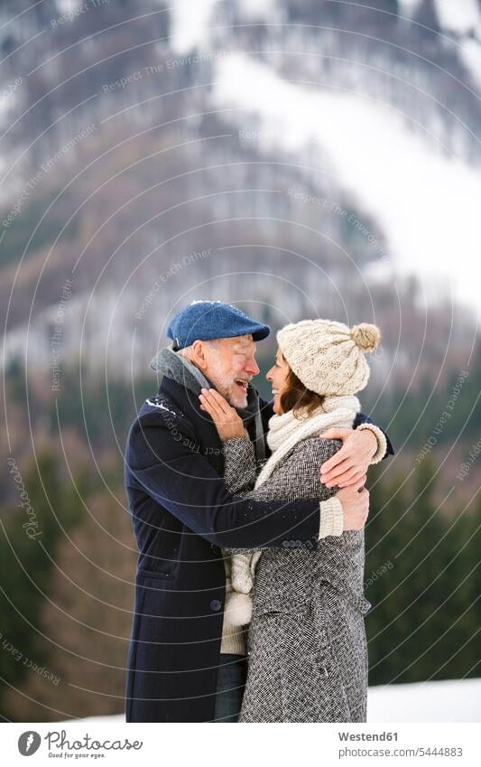 Happy senior couple in winter landscape hibernal elder couples senior couples adult couple adult couples twosomes partnership people persons human being humans