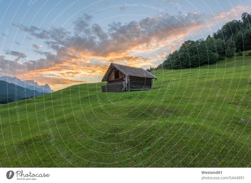 Germany, Bavaria, Werdenfelser Land, hay barn at sunrise cloud clouds morning light nature natural world building buildings outdoors outdoor shots location shot
