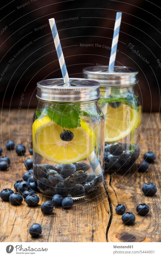 Two glasses of infused water with lemon slices, blueberries and mint scattered cover lid Lids healthy Pepper mint peppermint Mineral Water Minerals ready to eat
