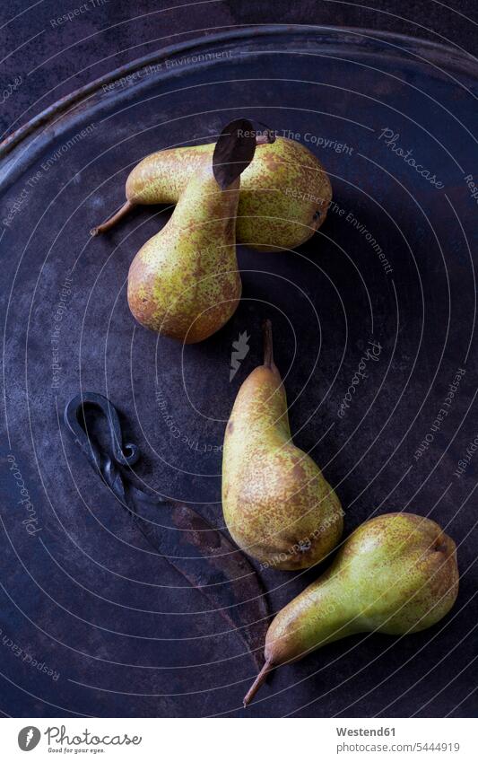 Four green pears 'Abate Fetel' and an old knife on rusty ground nobody knives Fruit Fruits sort sorts Leaf Leaves rusting rusted wrought iron wrought-iron metal