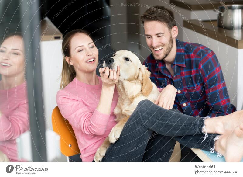 Happy young couple with dog at home dogs Canine twosomes partnership couples happiness happy pets animal creatures animals people persons human being humans