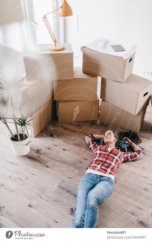 Mature woman moving house, lying on floor, thinking females women flat flats apartment apartments floors owner owners property move Moving Home ground land