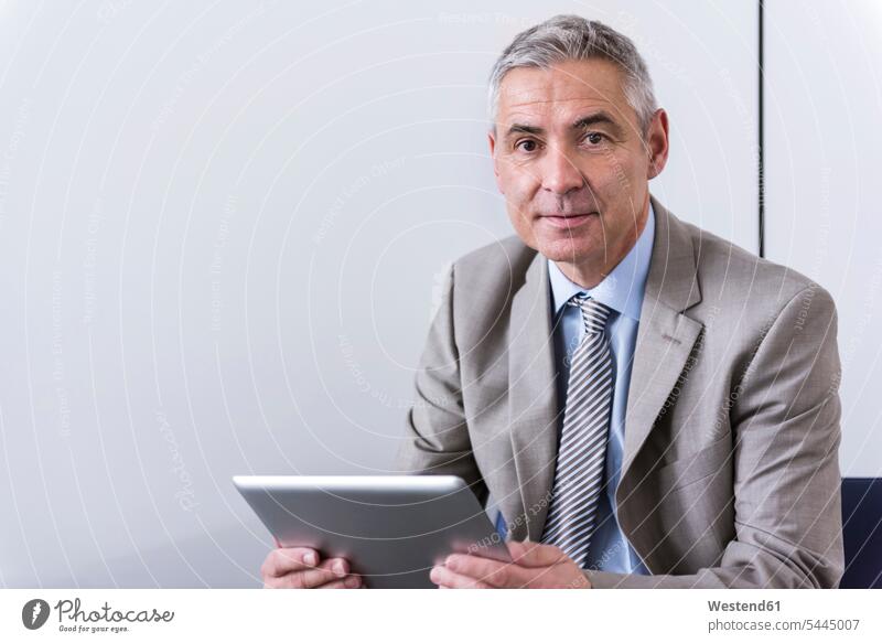 Portrait of a mature businessman, using digital tablet digitizer Tablet Computer Tablet PC Tablet Computers iPad Digital Tablet digital tablets expertise