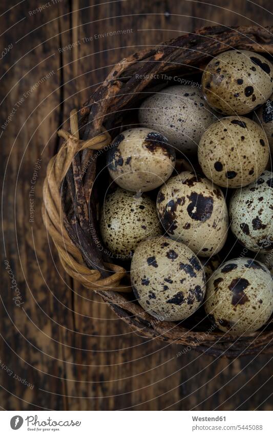 Wickerbasket of quail eggs on dark wood natural naturally close-up close up closeups close ups close-ups Part Of partial view cropped brown rustic dotted