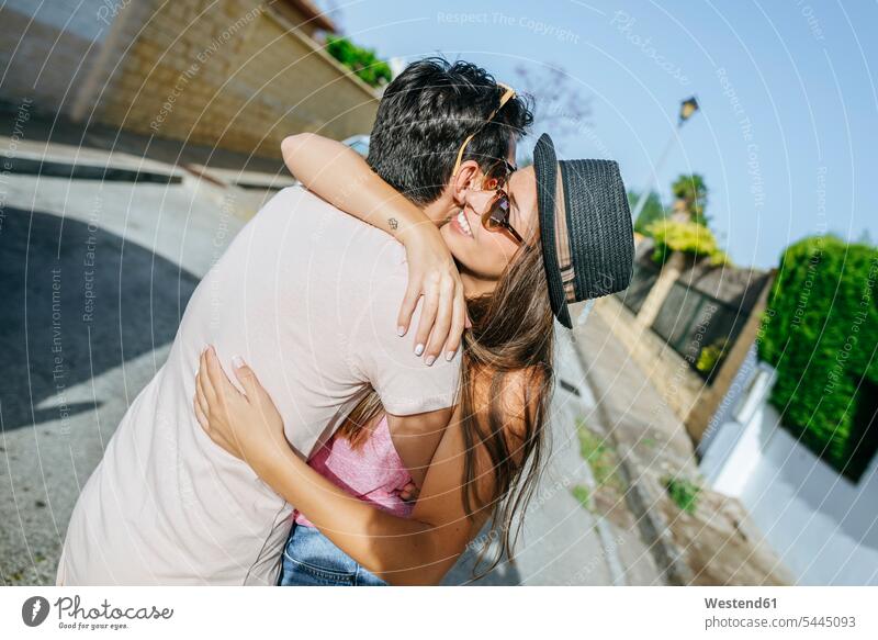 Couple embracing on the street embrace Embracement hug hugging Fun having fun funny couple twosomes partnership couples people persons human being humans