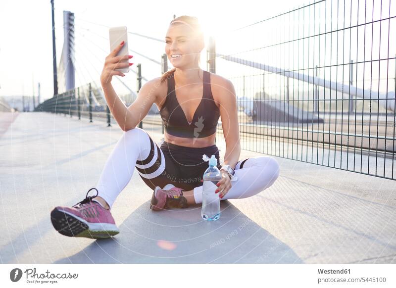 Fit woman taking selfie after outdoor workout Selfie Selfies working out work out urban urbanity Smartphone iPhone Smartphones fit females women mobile phone