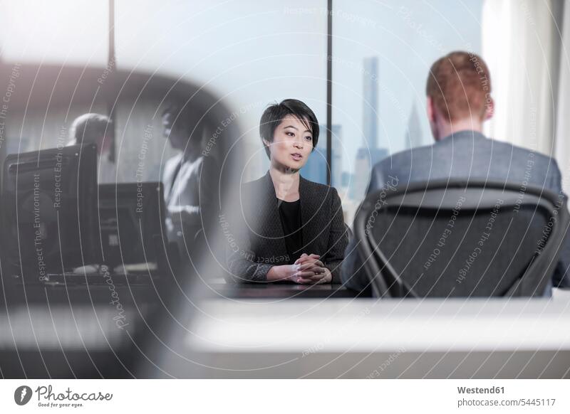 Woman and man talking at desk in office offices office room office rooms speaking workplace work place place of work business business world business life
