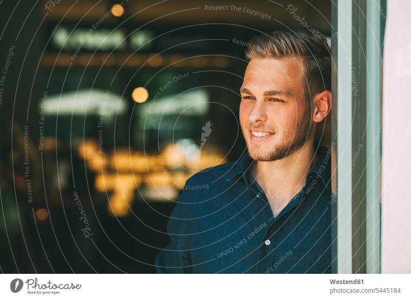 Portrait of smiling young man looking at distance men males portrait portraits Adults grown-ups grownups adult people persons human being humans human beings
