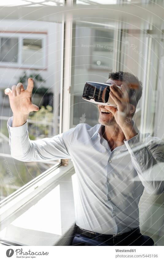 Businessman at the window wearing VR glasses Virtual Reality Business man Businessmen Business men office offices office room office rooms business people