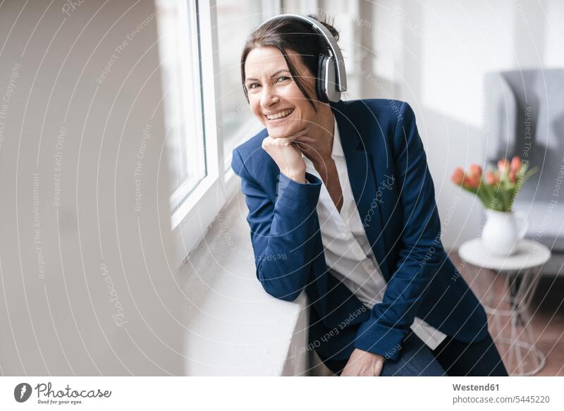 Portrait of woman listening music with headphones portrait portraits headset businesswoman businesswomen business woman business women females business people