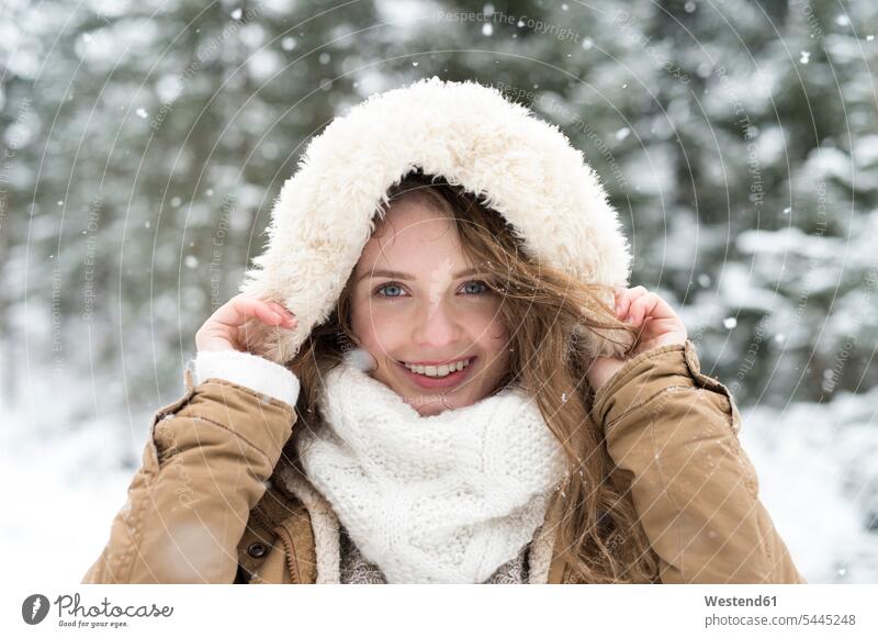Portrait of smiling young woman in winter hood hoods portrait portraits females women Adults grown-ups grownups adult people persons human being humans