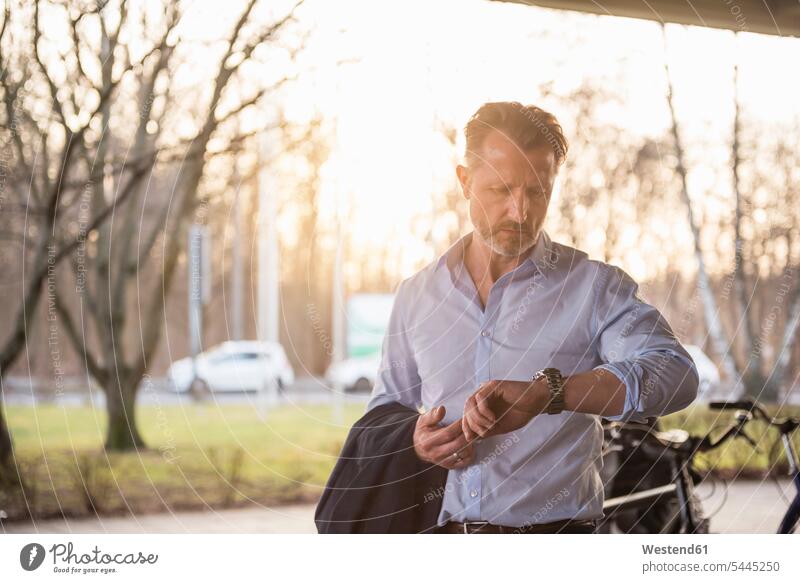 Portrait of mature man checking the time Businessman Business man Businessmen Business men waiting business people businesspeople business world business life