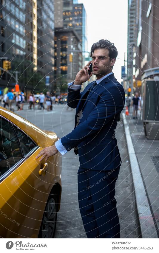 Businessman on the phone entering ywllow taxi in Manhattan attractive beautiful pretty good-looking Attractiveness Handsome call telephoning On The Telephone
