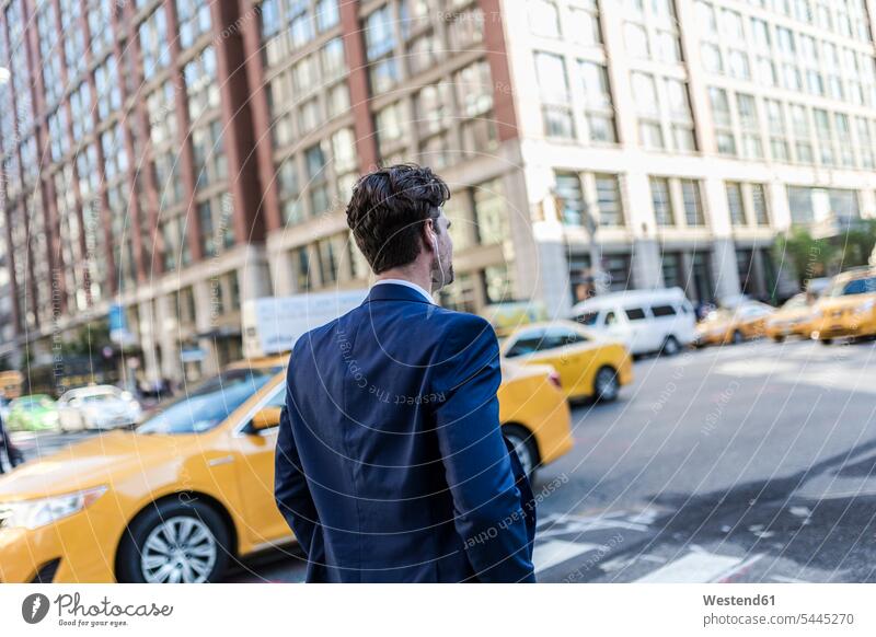 Businessman in the streets of Manhattan with yellow cab in background attractive beautiful pretty good-looking Attractiveness Handsome on the phone call