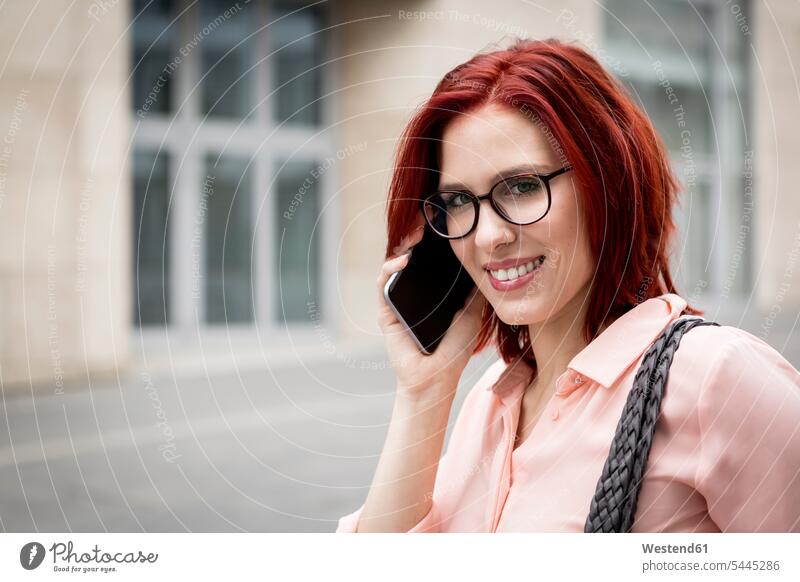 Young businesswoman in the city talking on the phone friendly nice young smart smart casual smart-casual Business Casual well dressed Smartphone iPhone
