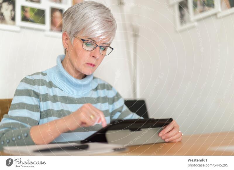 Senior woman using tablet at home use senior women elder women elder woman old senior woman digitizer Tablet Computer Tablet PC Tablet Computers iPad