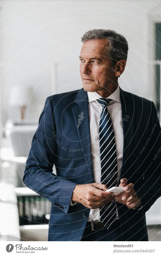 Portrait of mature businessman with cell phone portrait portraits Businessman Business man Businessmen Business men Smartphone iPhone Smartphones