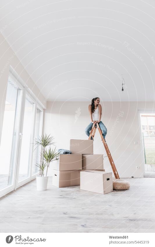 Mature woman sitting on ladder in her new home females women flat flats apartment apartments property owner owners moving house move Moving Home Seated Adults