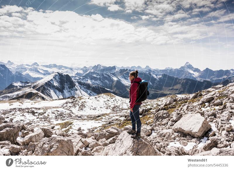 Germany, Bavaria, Oberstdorf, woman standing on rock in alpine scenery rocks females women hiking hike mountain range mountains mountain ranges Adults grown-ups