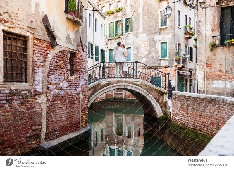 Italy, Venice, bridal couple standing on little bridge twosomes partnership couples bridal couples people persons human being humans human beings married couple