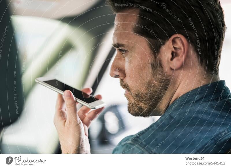 Businessman sitting in car talking on the phone, leaving voice mail caucasian caucasian ethnicity caucasian appearance european wireless Wireless Connection