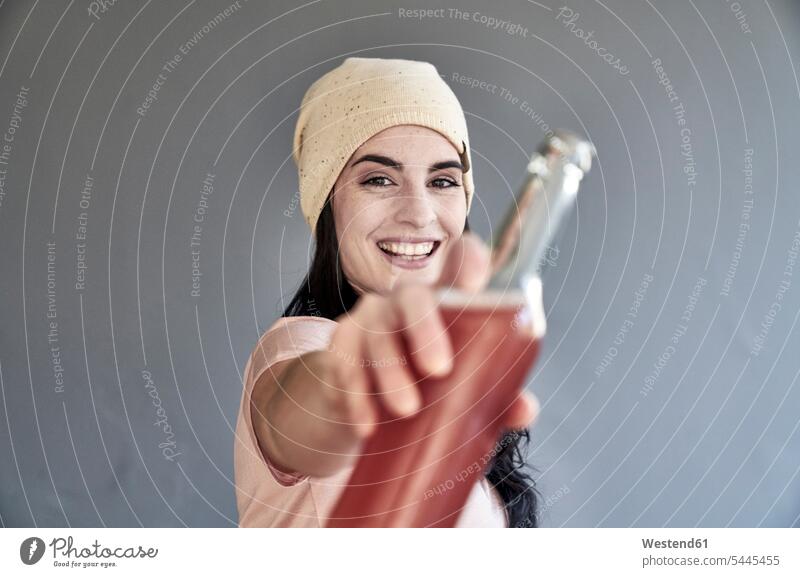 Portrait of smiling young woman holding bottle smile Bottle Bottles females women Adults grown-ups grownups adult people persons human being humans human beings
